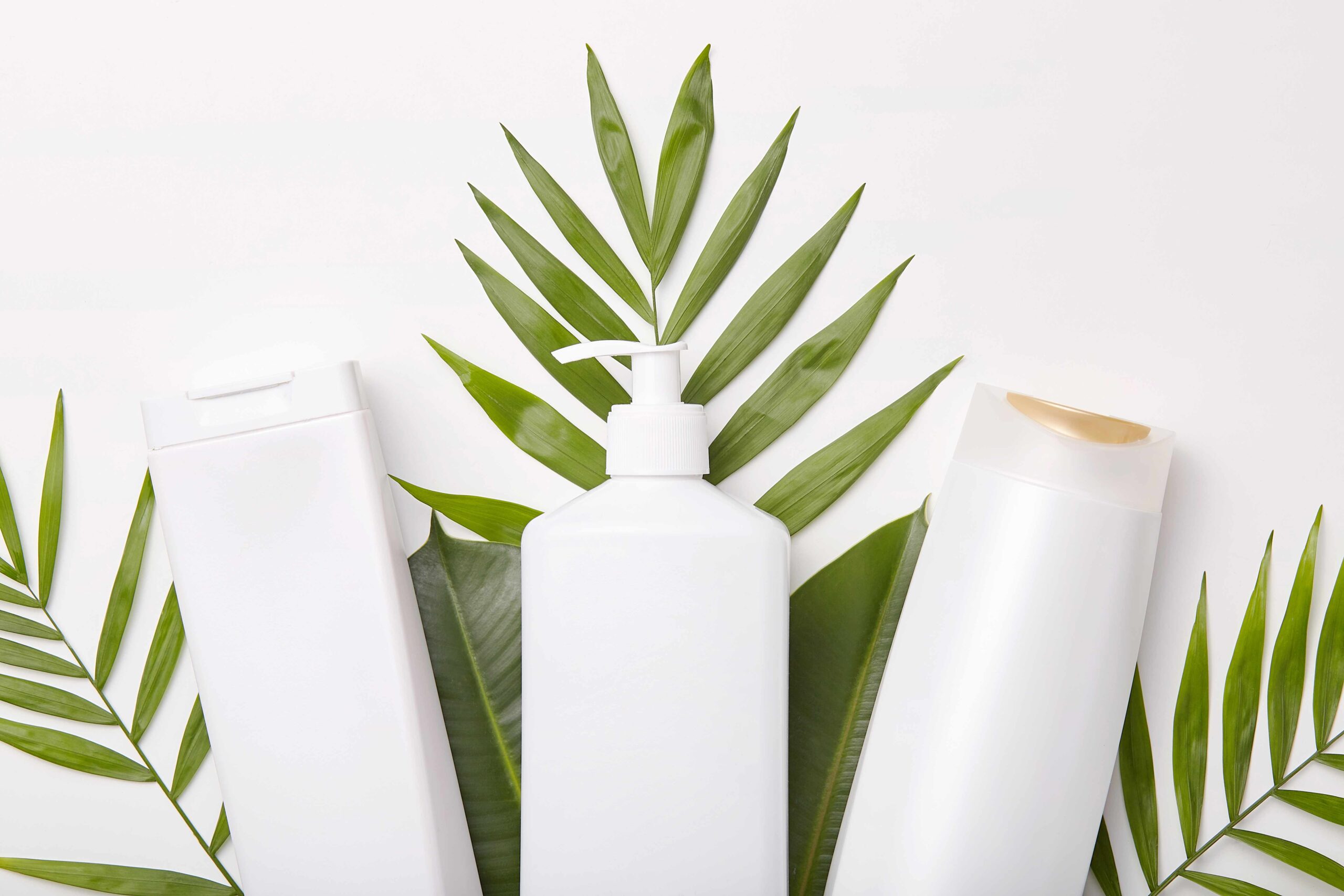 horizontal-shot-cosmetic-products-against-greenery-leaves